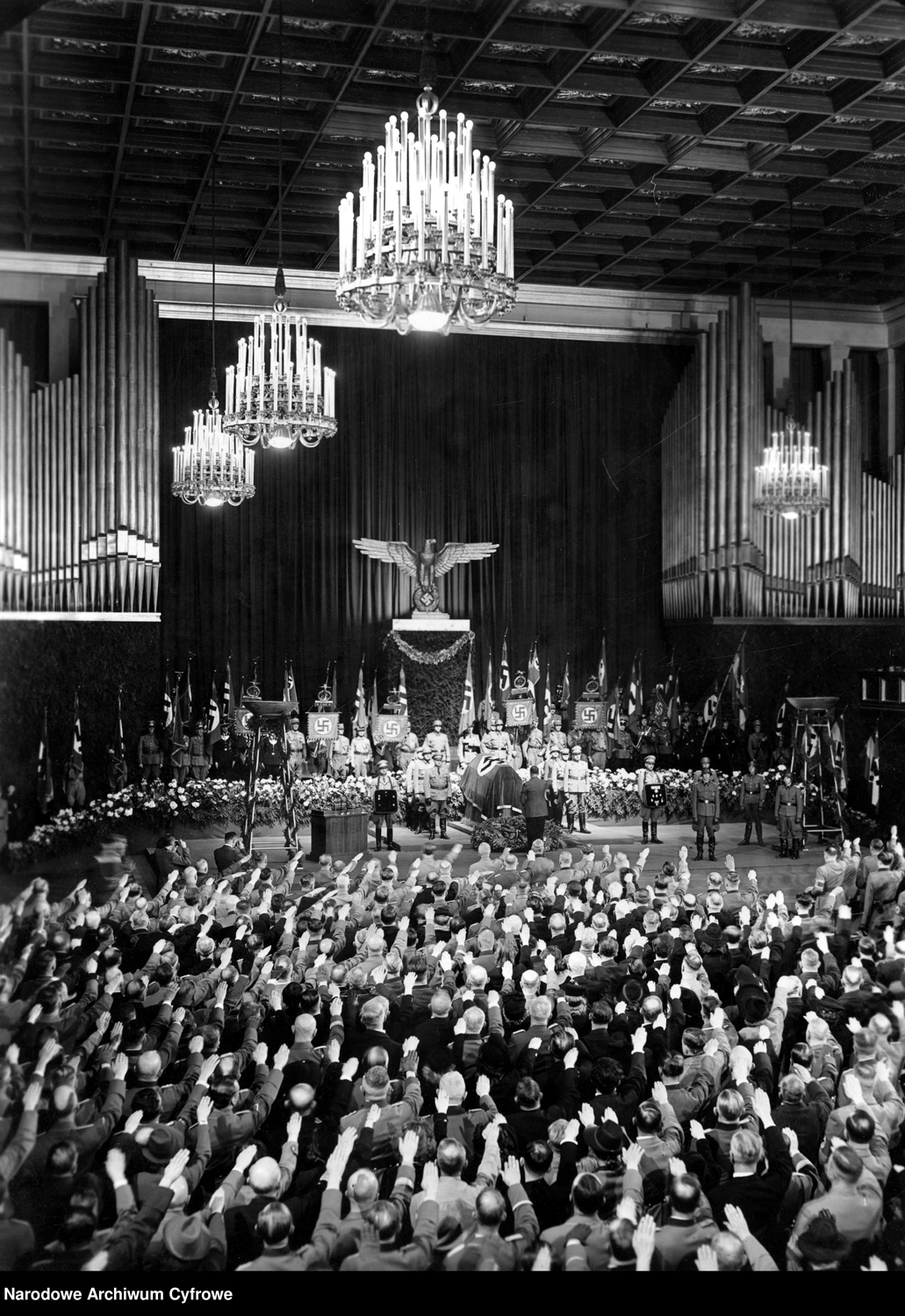 Adolf Hitler salutes at the funeral of Adolf Wagner in the congress hall of Munich's Deutsches Museum